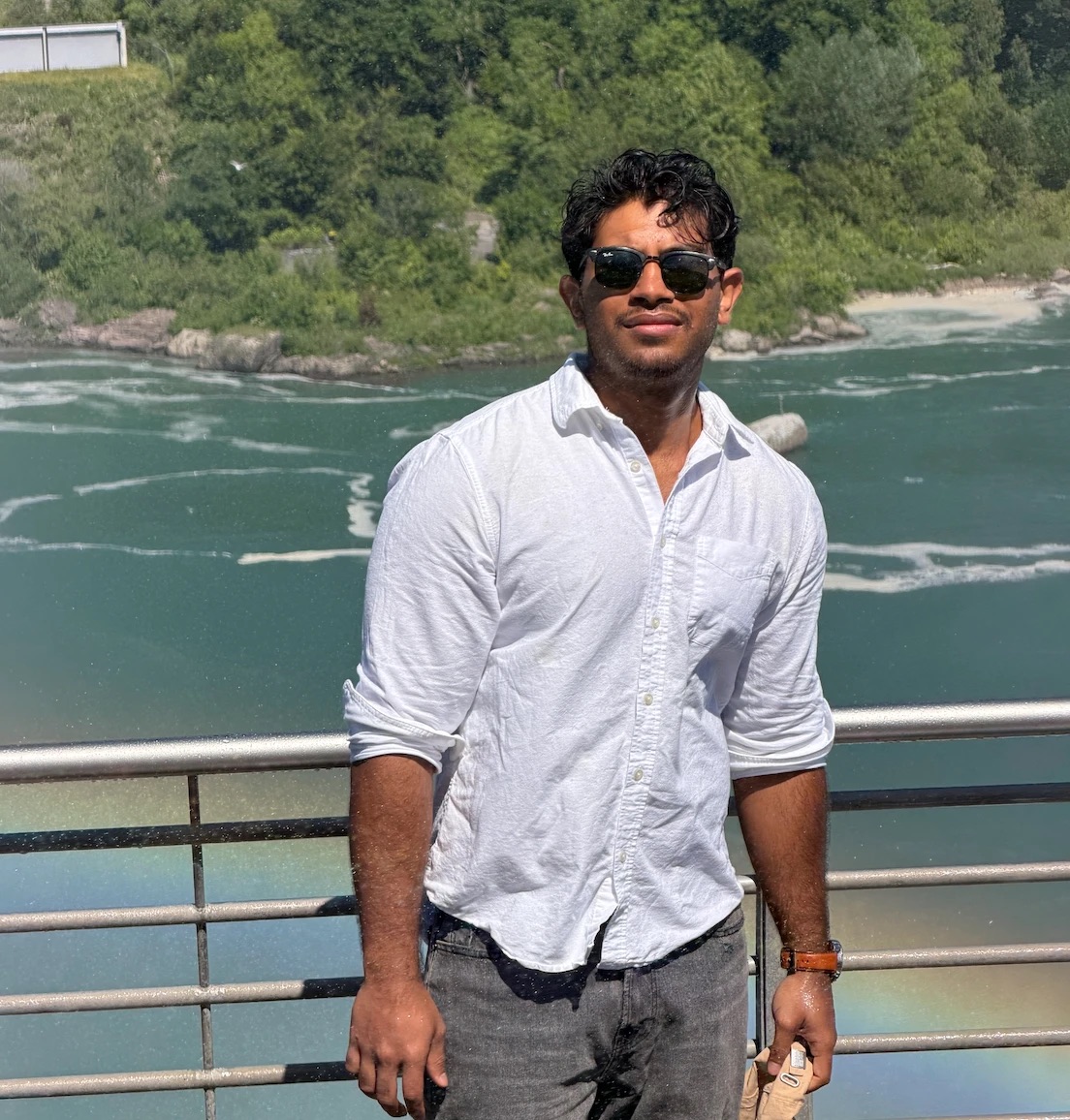 MD Rabbi in a white shirt by a river on a summer day